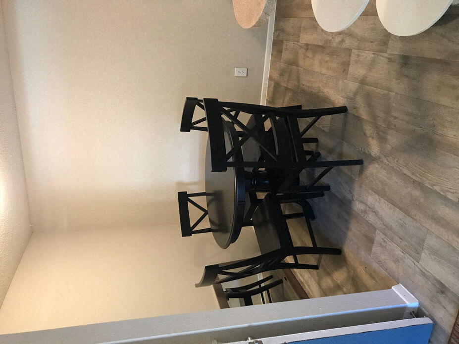 a group of black tables and chairs in a room