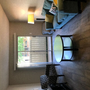 a living room with a mirror and a window