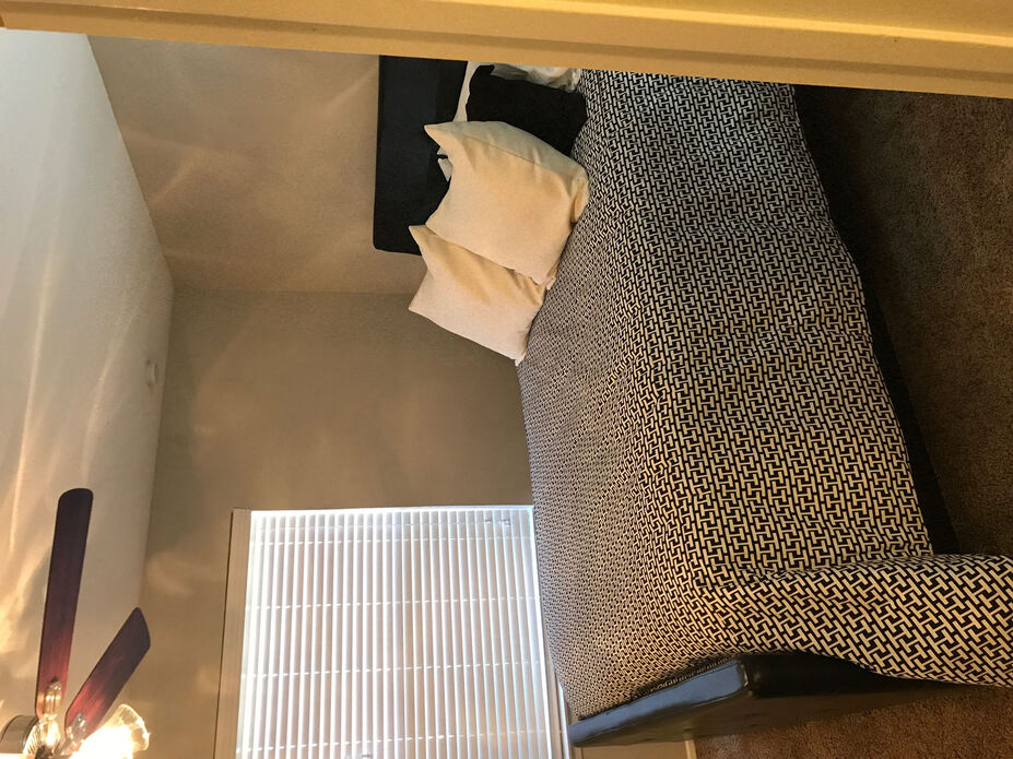 a hotel room with a bed and a window