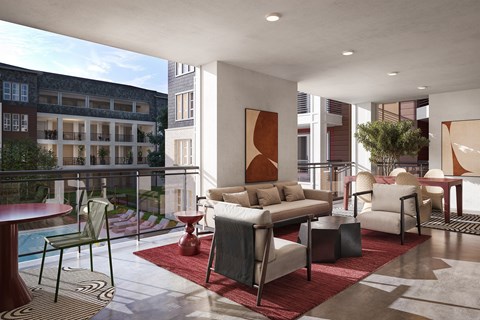 A modern living room with a pool table and a balcony overlooking a building.