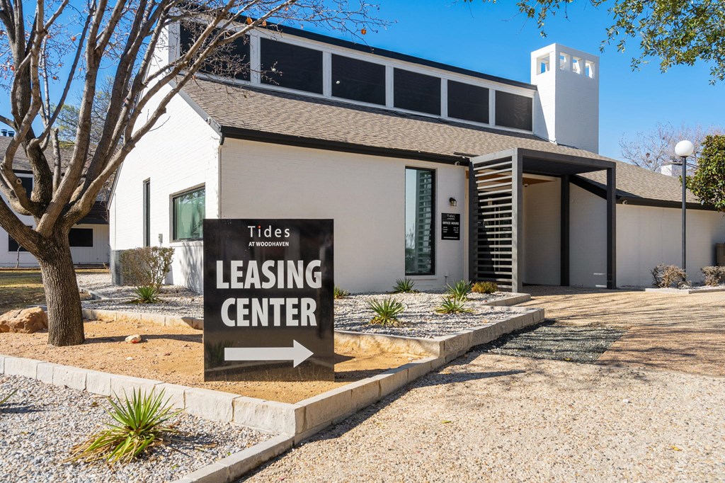 a building with a leasing center sign in front of it
