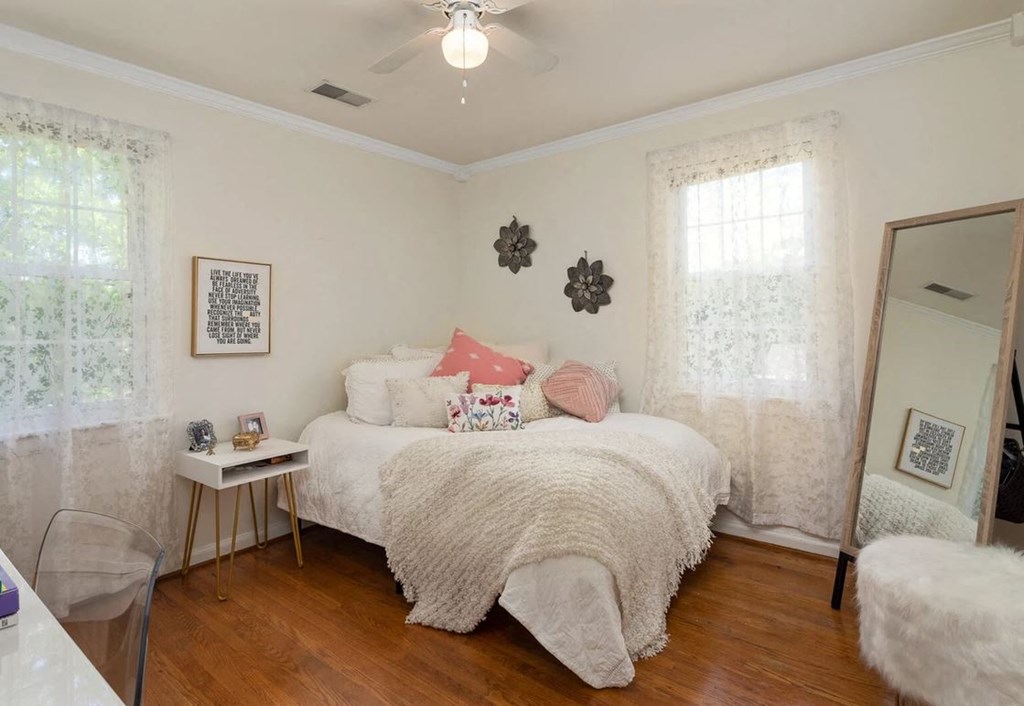 a bedroom with a bed and a mirror