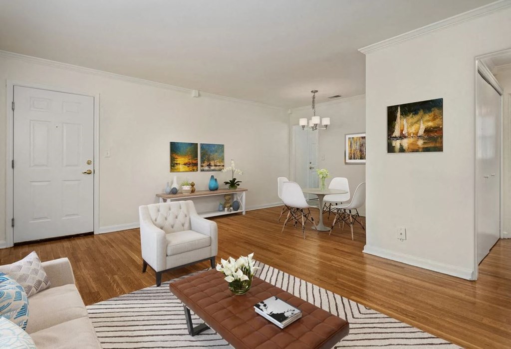 a living room with a couch and a table with chairs