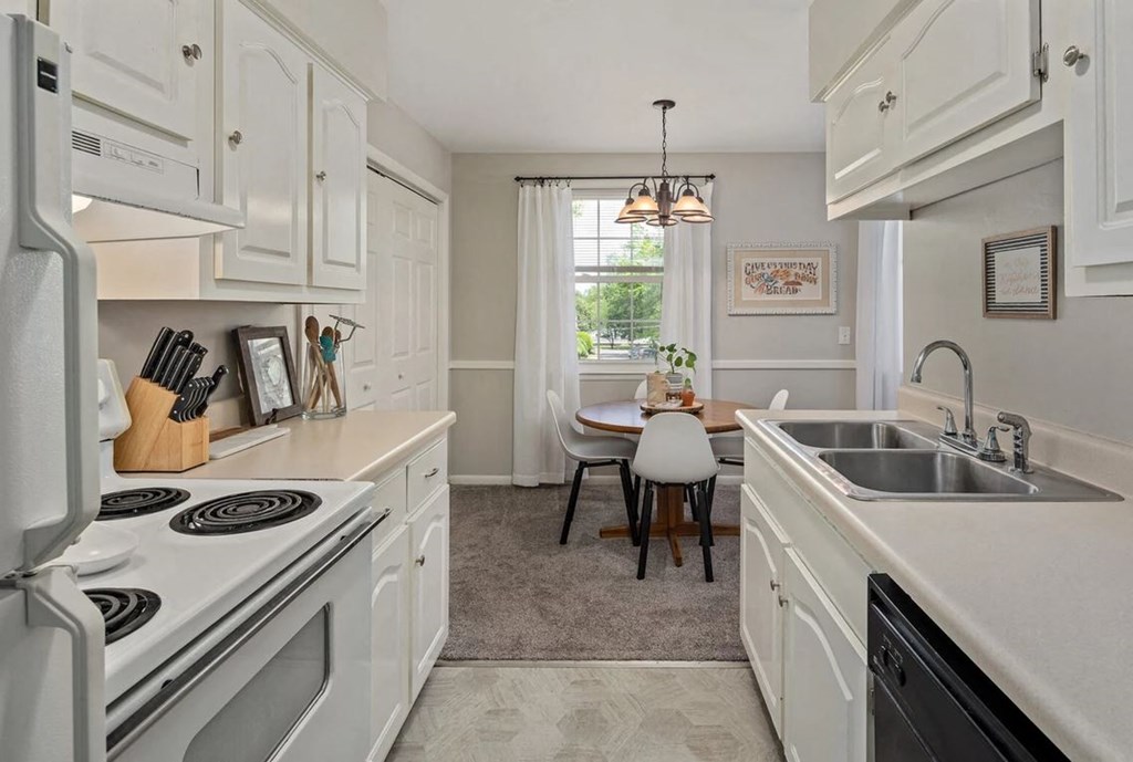 a kitchen with a stove top oven and a sink