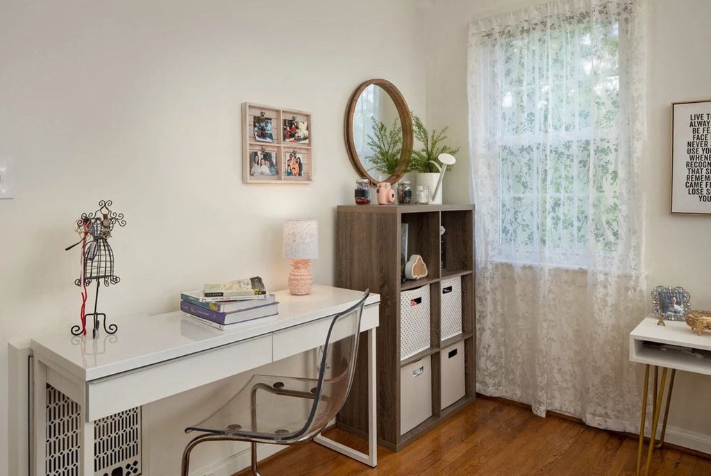 a home office with a desk and a mirror