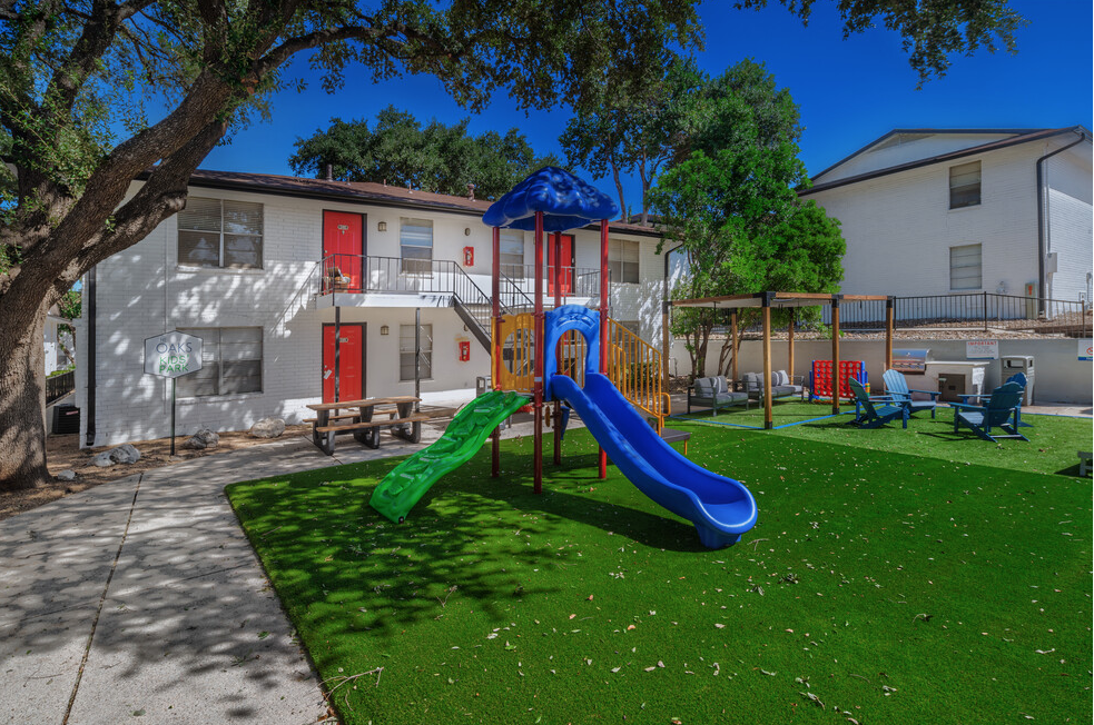 a childrens playroom with a seesaw and other playground equipment
