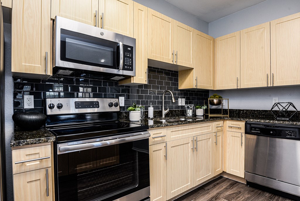 a kitchen with black appliances and wooden cabinets