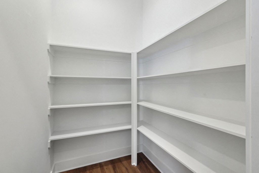 Empty white shelves in a room.