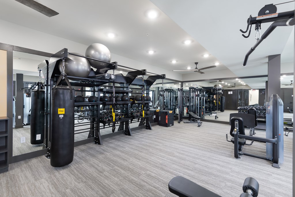A gym with a variety of equipment including a leg press machine.