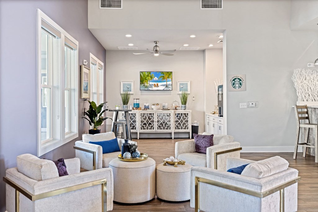 A living room with white furniture and a coffee table.