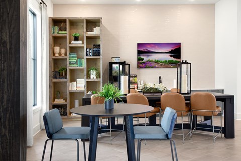 A modern dining room with a round table and chairs.