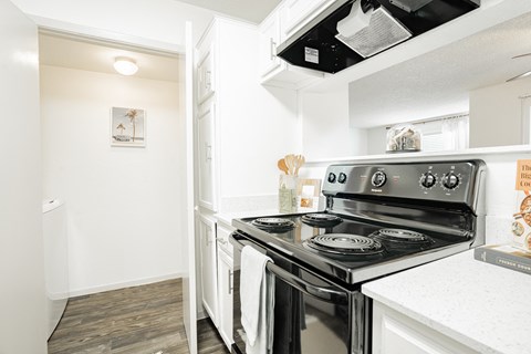 a white kitchen with an oven and a counter top