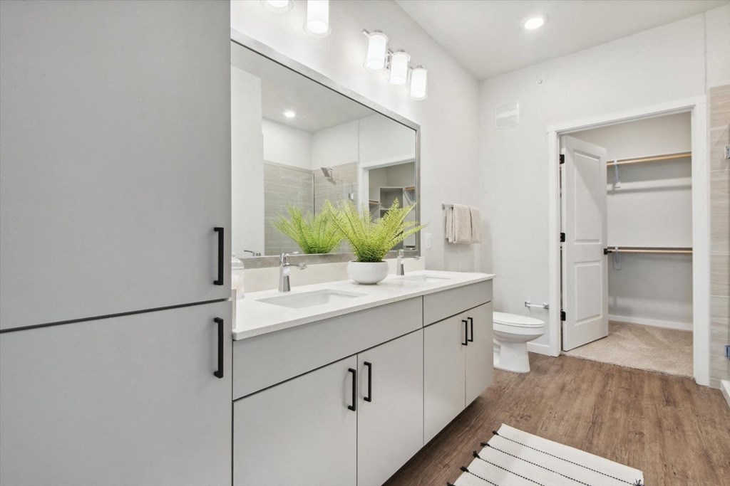a white bathroom with a sink and a mirror
