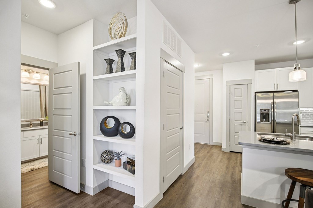 A white kitchen with a bar stool.