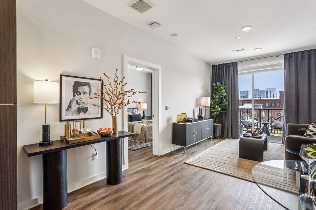 A modern living room with a black and white framed picture on the wall.