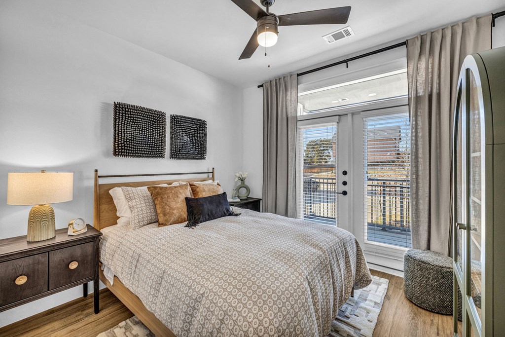 a bedroom with a bed and a large window