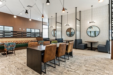 A modern dining area with a long table and chairs.