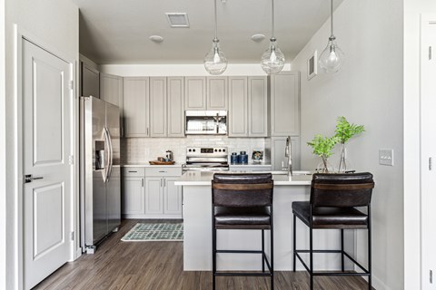 A kitchen with a white cabinet and a white fridge.