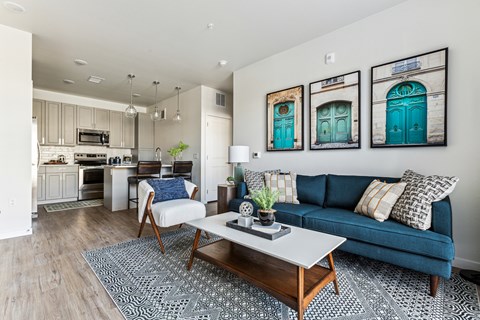 A living room with a blue couch and a coffee table.