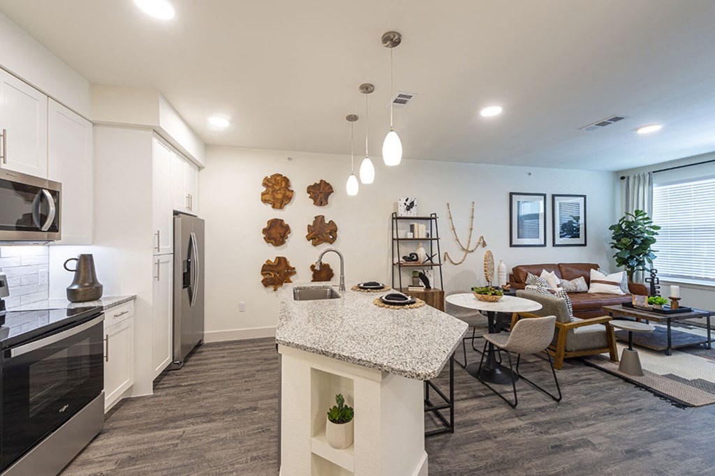 a living room with a kitchen and a dining room