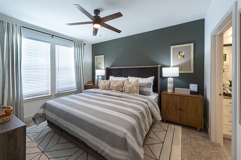 a bedroom with a bed and a ceiling fan