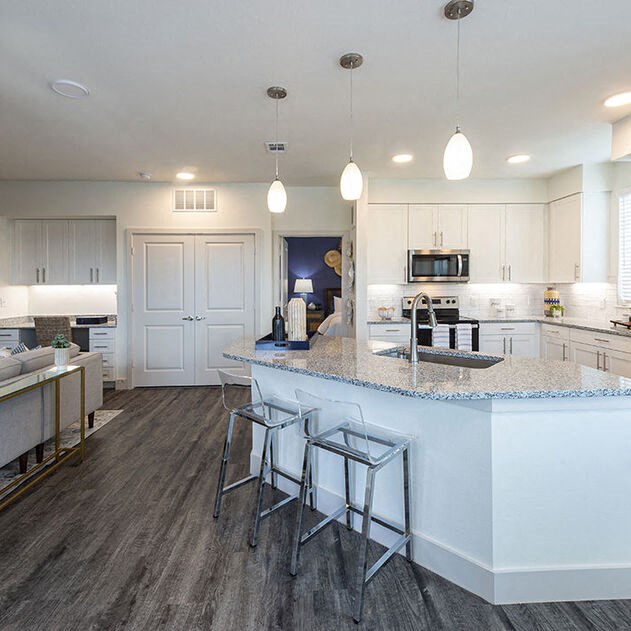 a kitchen with a counter top and bar stools