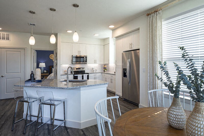 a large kitchen with a table and chairs