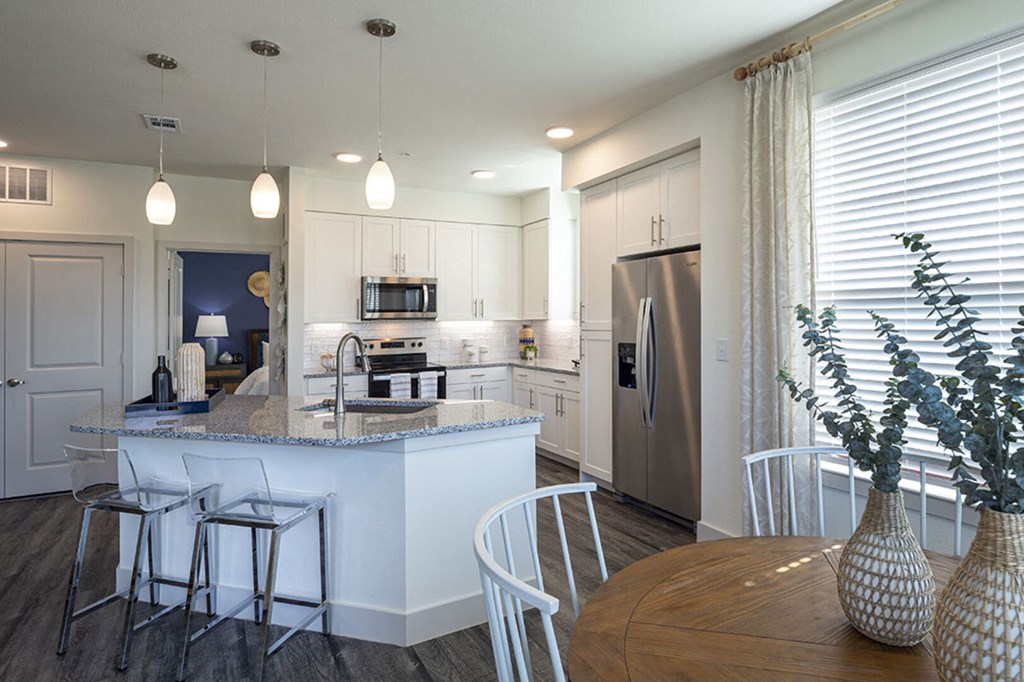 a kitchen with an island and a table with chairs