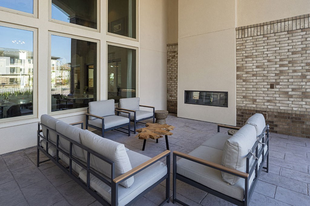 a living room with couches and chairs and a fireplace