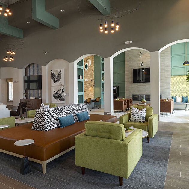 a large living room with a couch and chairs