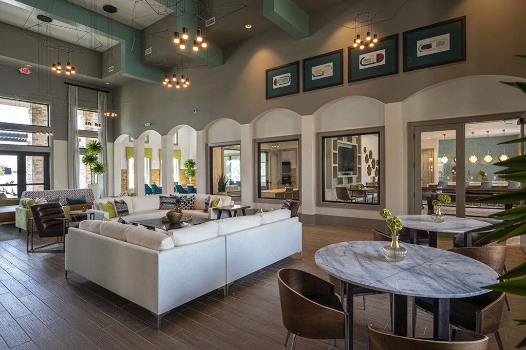 a living room with couches tables and chairs