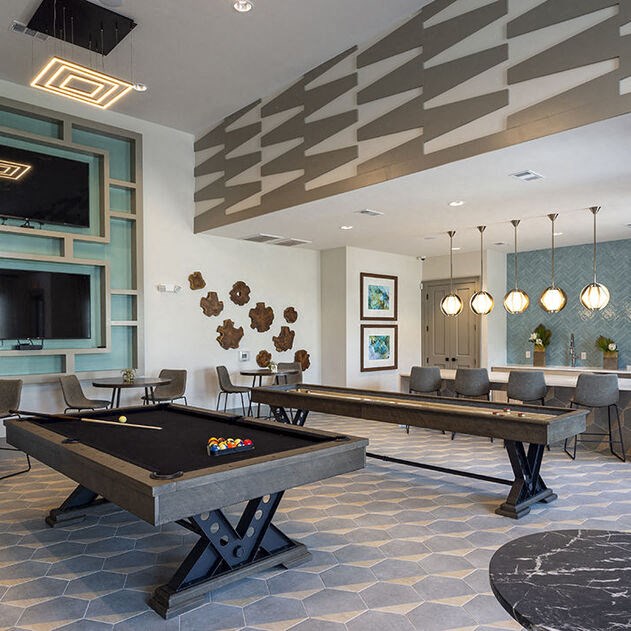 a game room with a pool table and a television