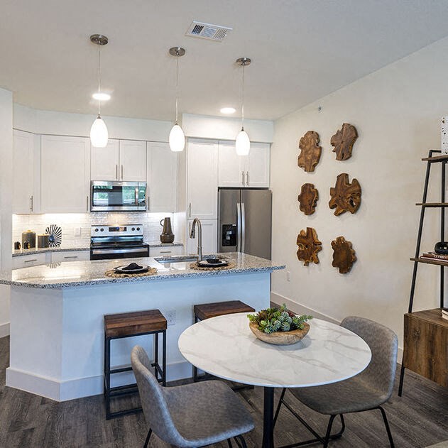 a kitchen and dining room with a table and chairs