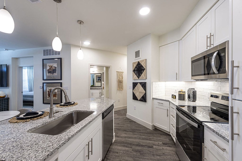 a kitchen with granite counter tops and a sink