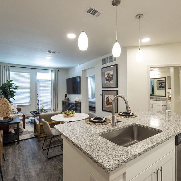 a kitchen and a living room with a sink