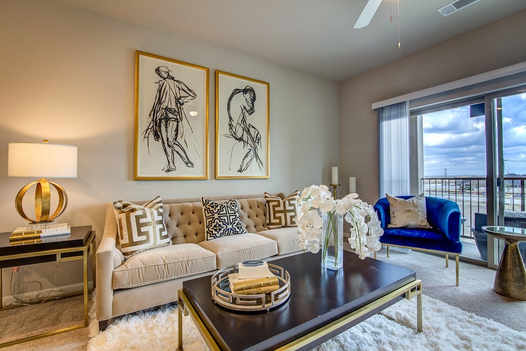 a living room with a couch and a table with a vase of flowers on it