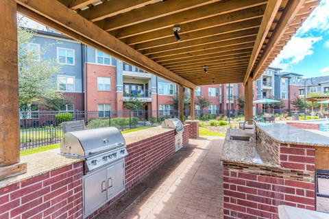 A patio with a grill and a BBQ box.
