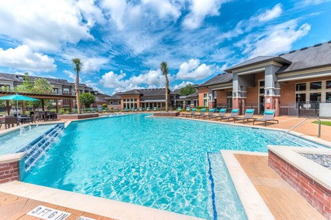 A large swimming pool with a blue tiled edge and a white line down the middle.