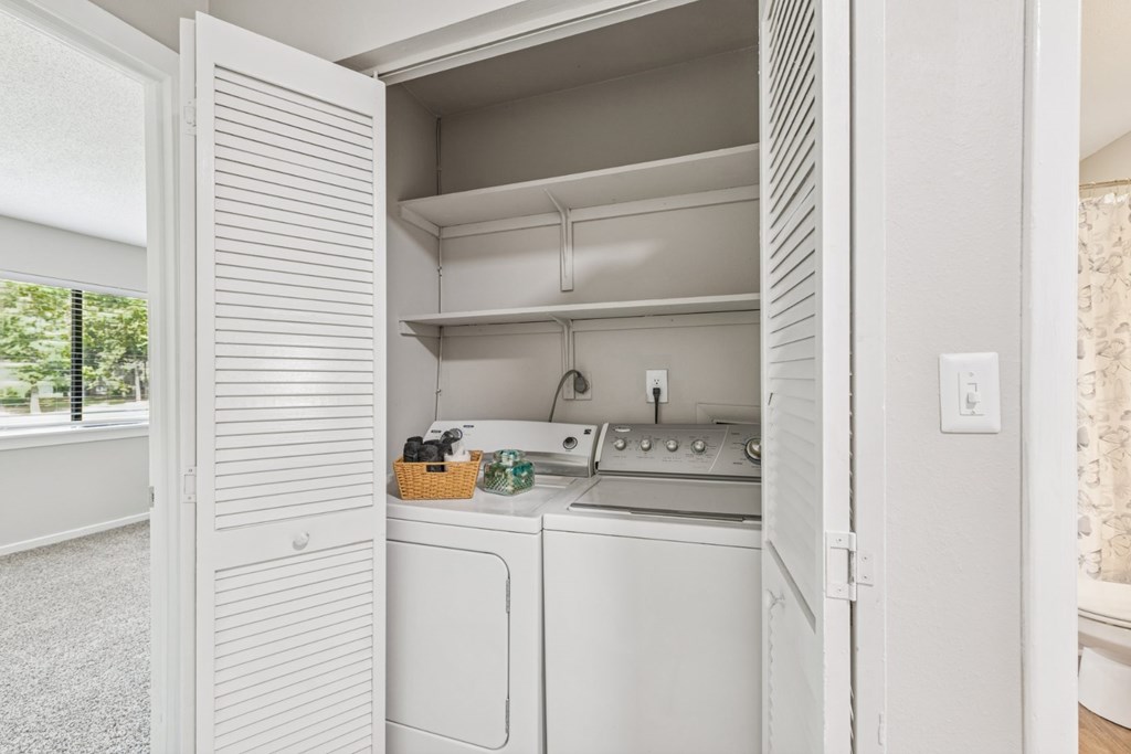 A white kitchen with a dishwasher and oven.