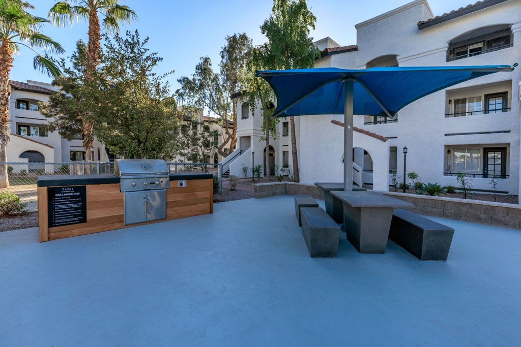 a backyard with a grill and picnic table