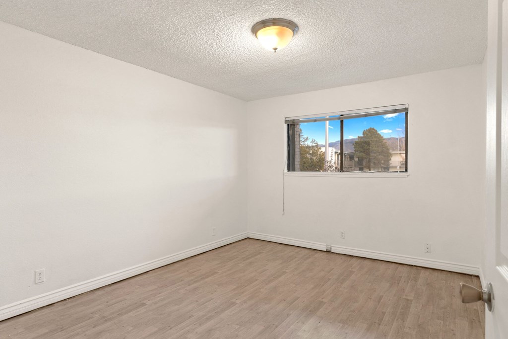 the living room of an empty house with a window