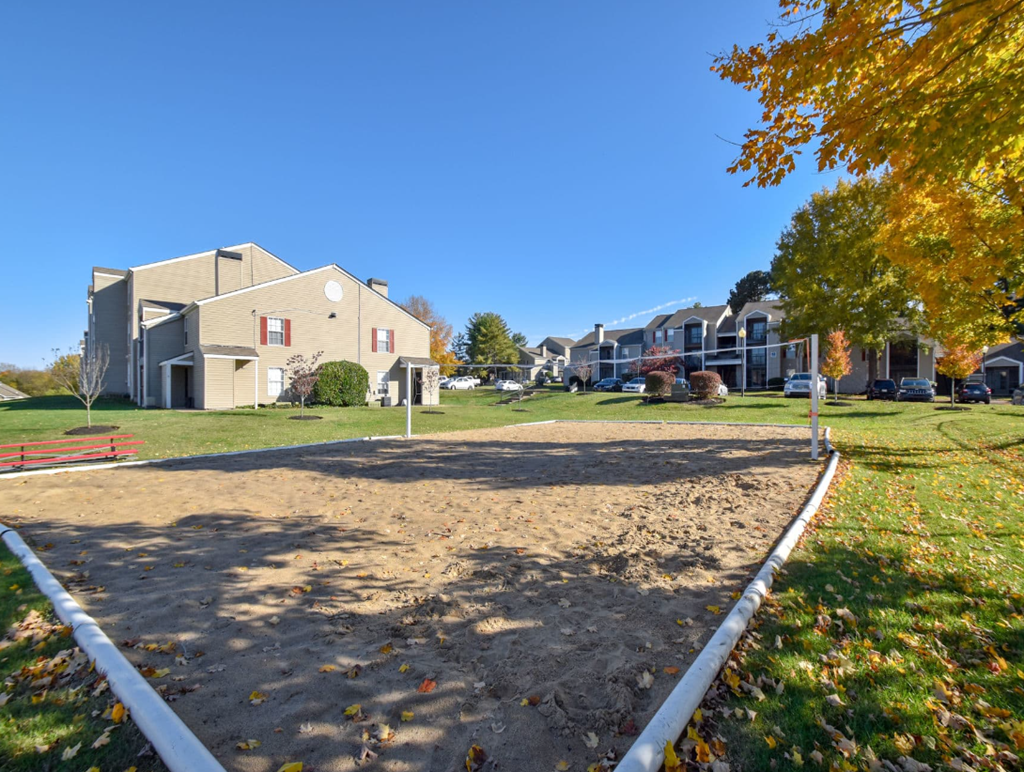a sandy volleyball court at the whispering winds apartments in pearland, tx