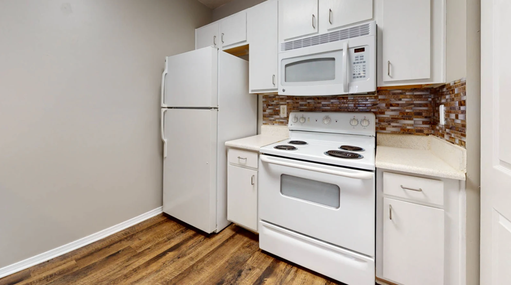 a kitchen with white appliances and a white refrigerator