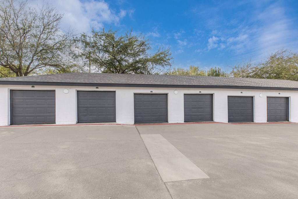 a row of garage doors in front of a building