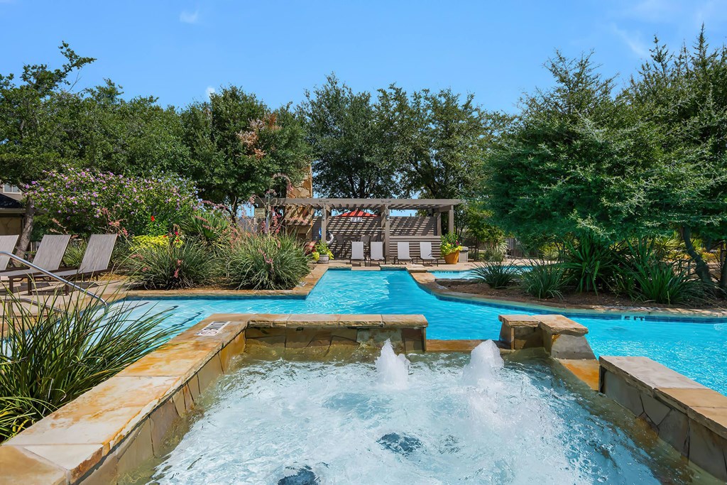 a swimming pool with a water feature in the middle