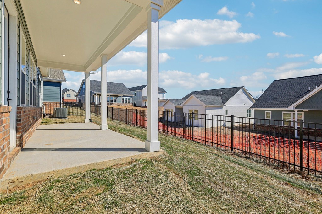 A residential area with houses and a fenced area.