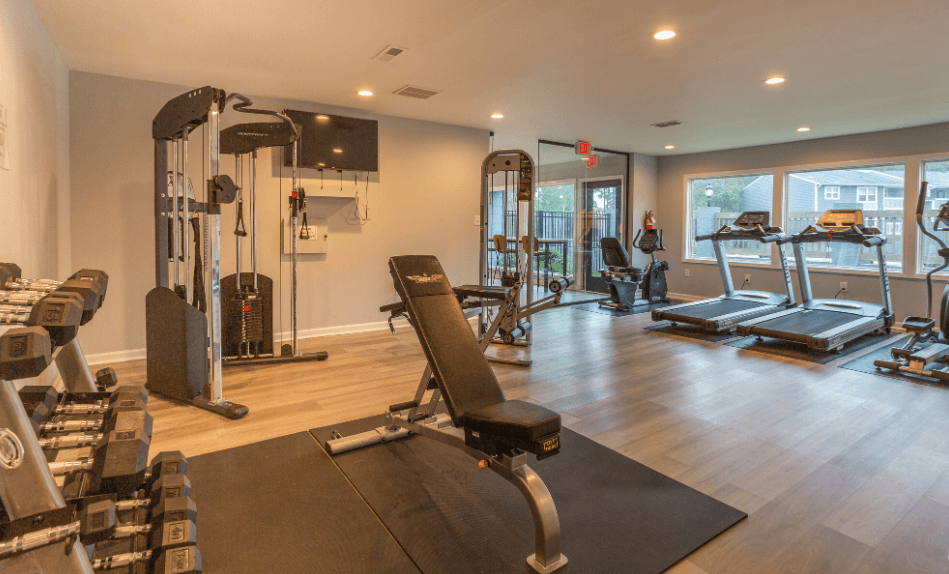 a home gym with exercise equipment and a large window