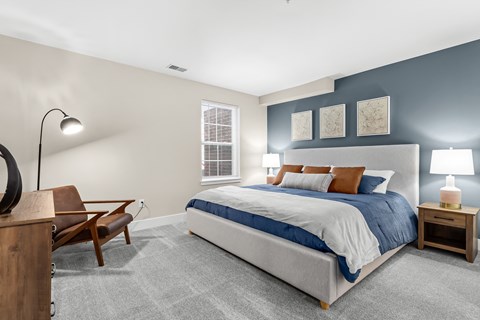 a bedroom with a bed and a desk with a chair