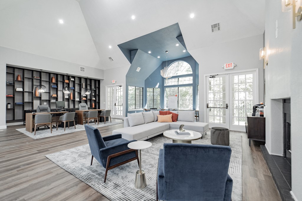 a living room with couches and chairs and a fireplace