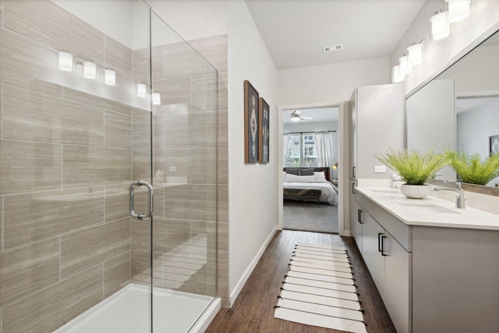 a bathroom with a shower and a sink in it